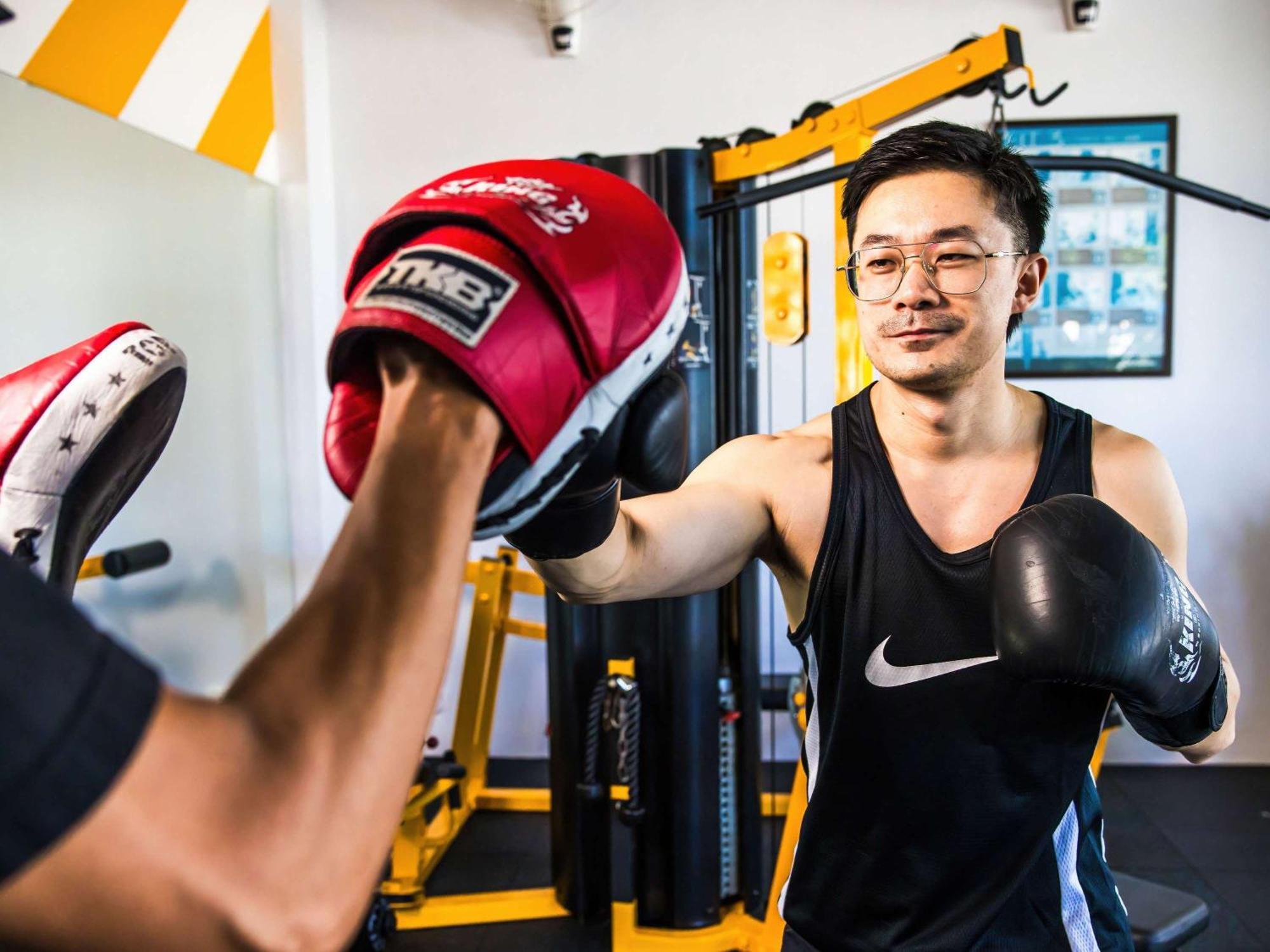 Grand Mercure Phuket Patong Εξωτερικό φωτογραφία A boxer training with a heavy bag